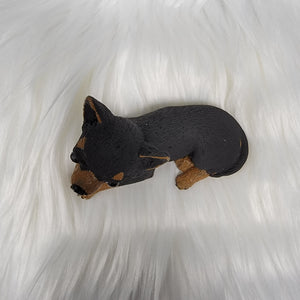 Black and Tan Chihuahua figurine made of concrete.