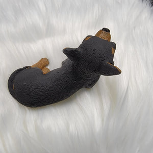 Black and Tan Chihuahua figurine made of concrete.