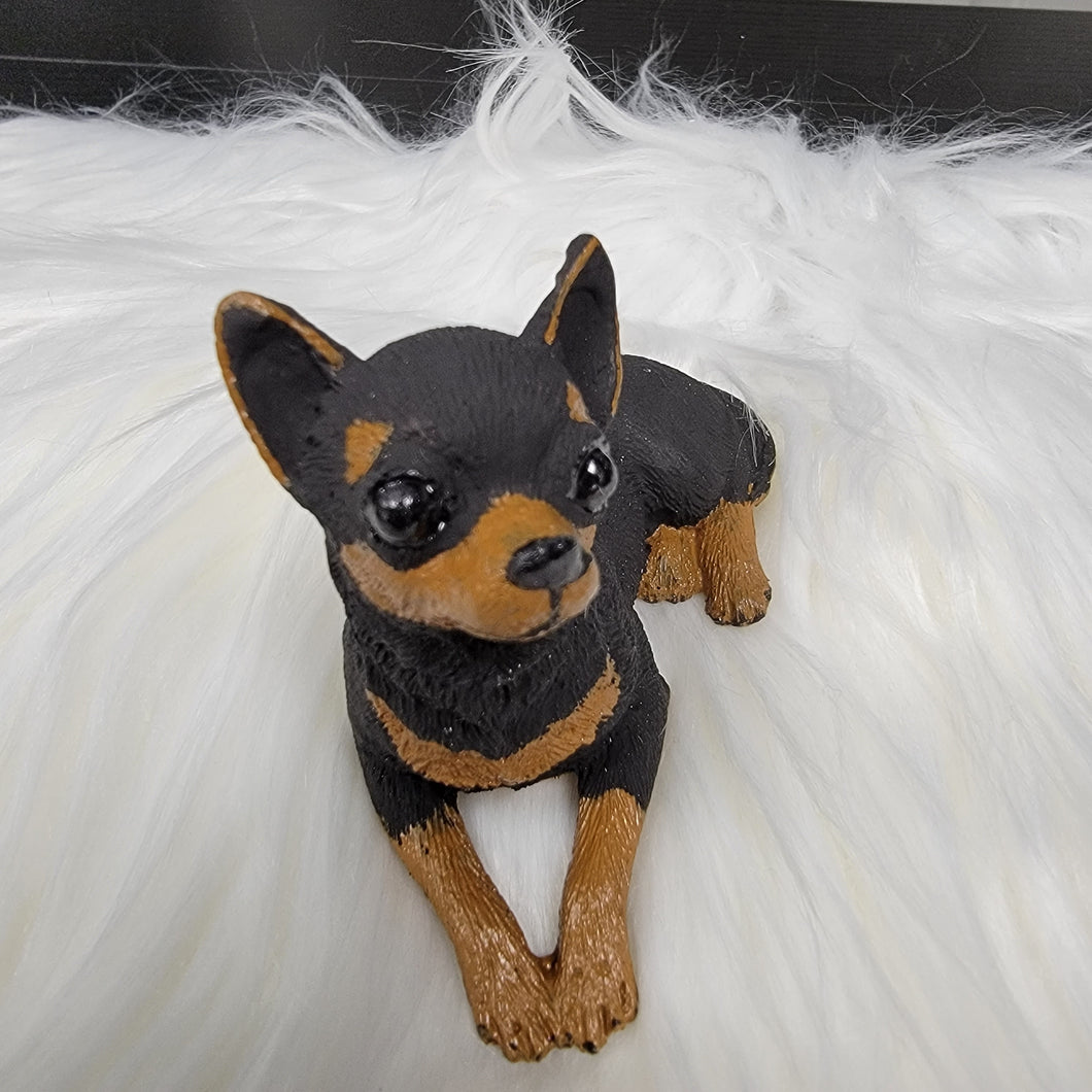 Black and Tan Chihuahua figurine made of concrete.